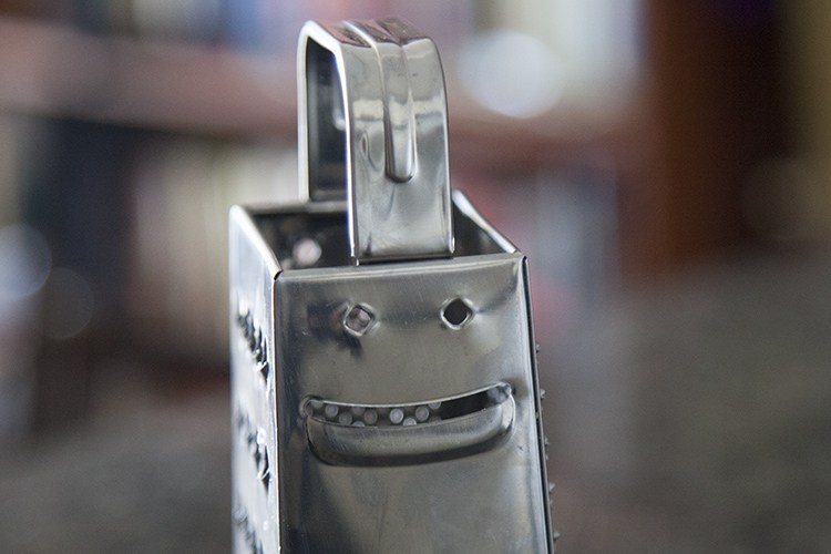 An example of pareidolia, this photo depicts a cheese grater that appears to be smiling.