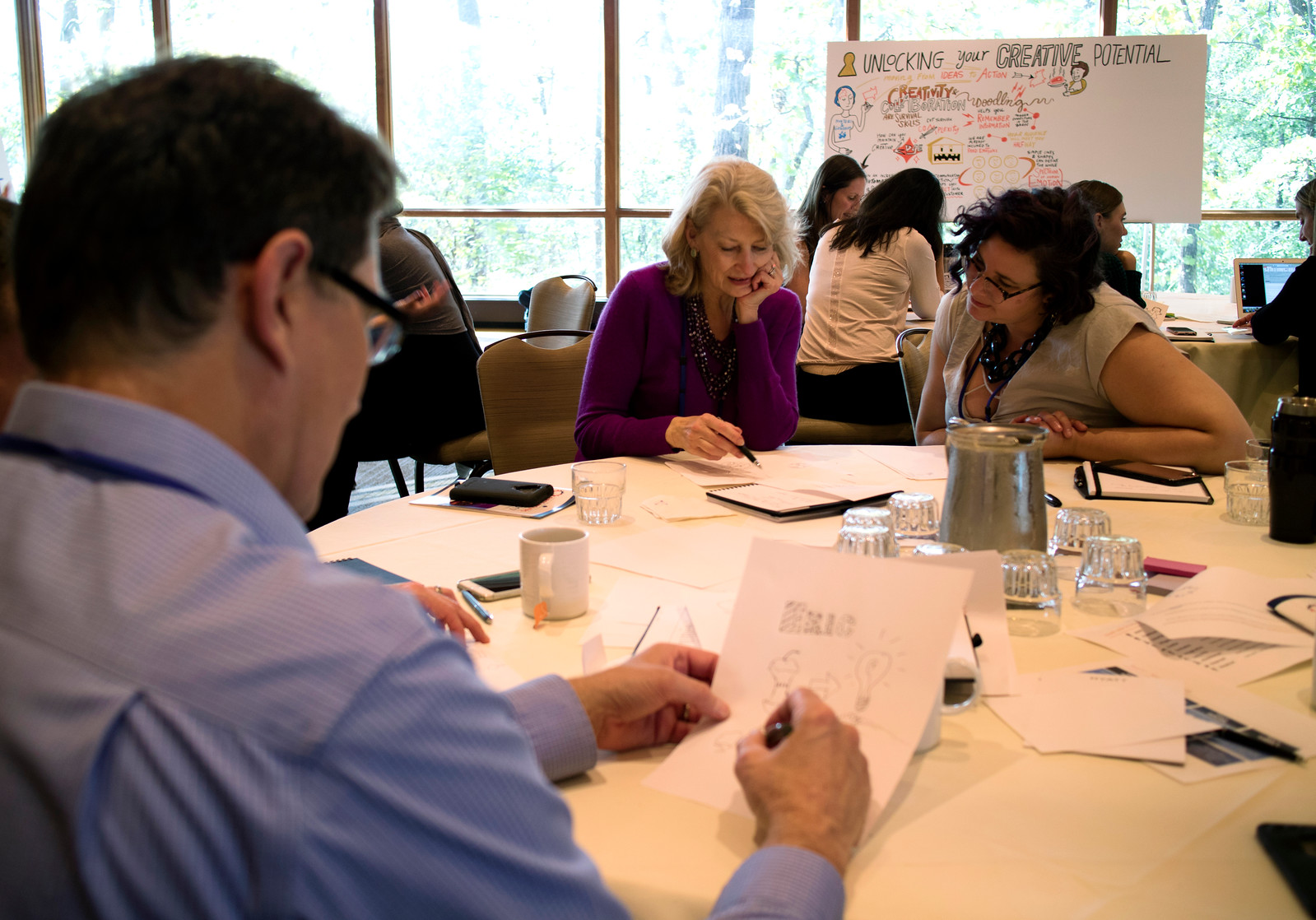 Participants in an ImageThink workshop developing visual bios, using drawings and words.