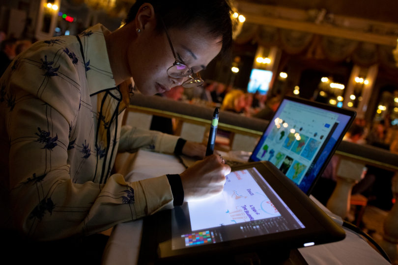 ImageThink graphic recorder scribing digitally on a Wacom Cintiq tablet live at an event.