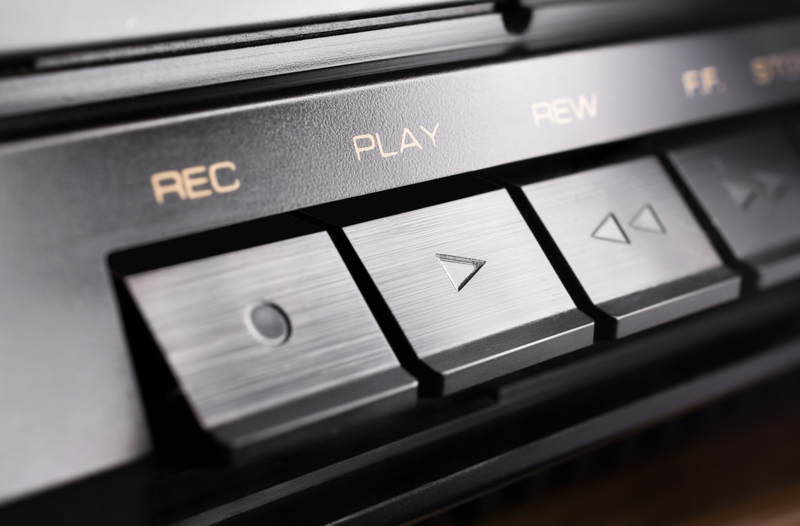 Image of an audio device with symbols of sound design - record, play, rewind, fast forward.