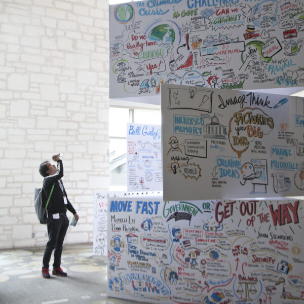 Audience member records an ImageThink social listening mural tower.