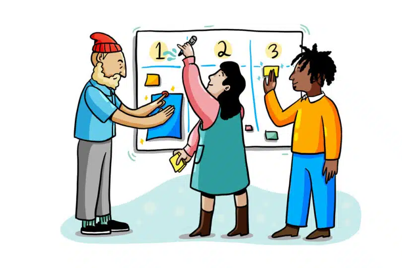 3 individuals collaborating at whiteboard