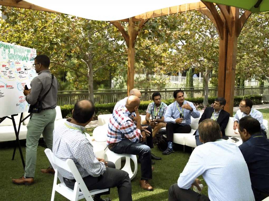 An individual contributing to visual scribing during a meeting. 