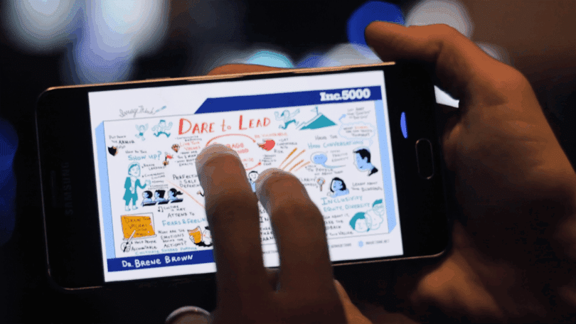 Person viewing shareable graphic recording visual notes on a smartphone.