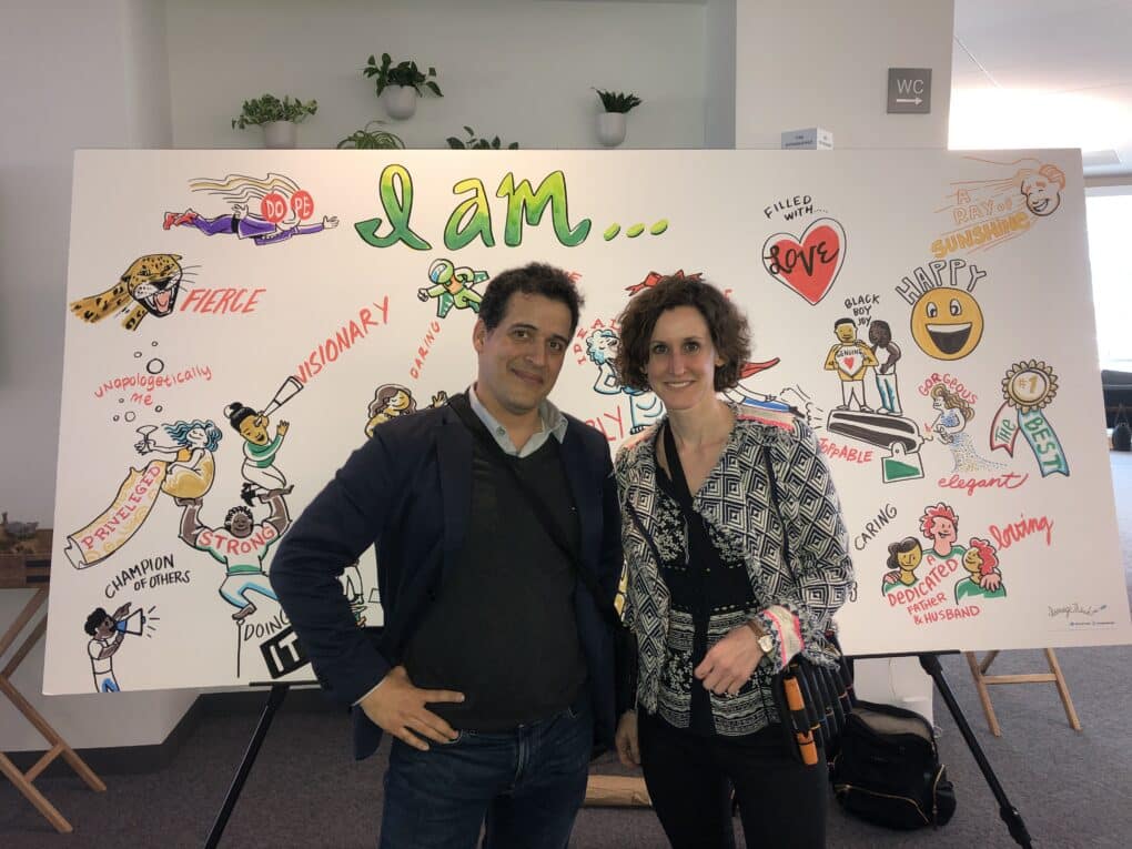 Two ImageThink visual strategists pose in front of a social listening mural at a Google SAGE event in Mountain View, California.