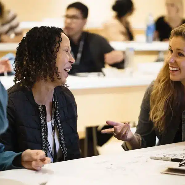Nonprofit team members smiling during a collaborative visual storytelling workshop.