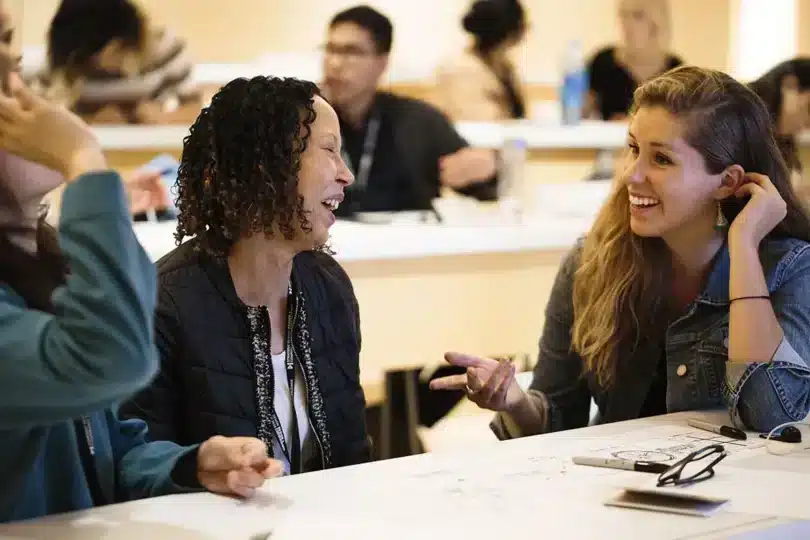 Nonprofit team members smiling during a collaborative visual storytelling workshop.