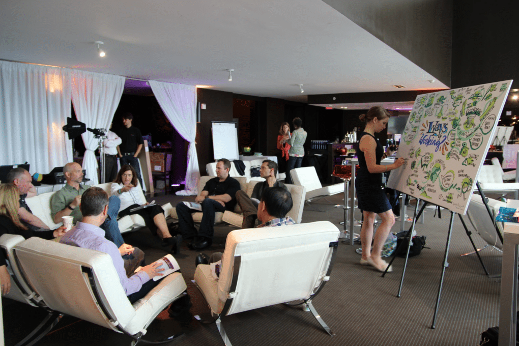 Audience members at a corporate town hall meeting engage with a presentation.