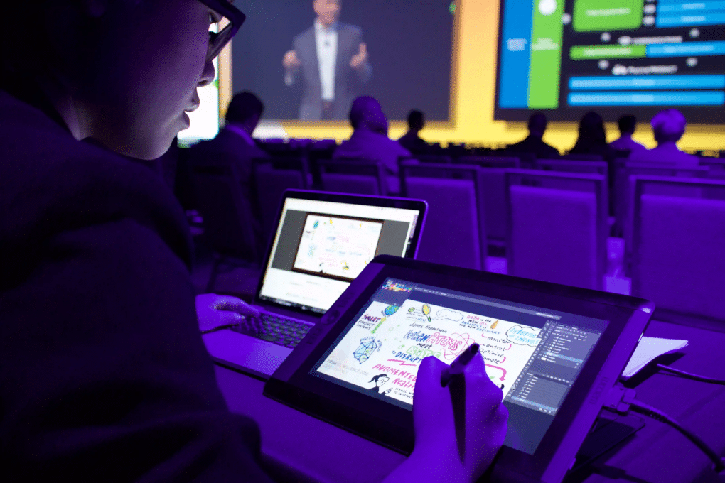 A digital graphic recorder captures live event insights on a tablet.